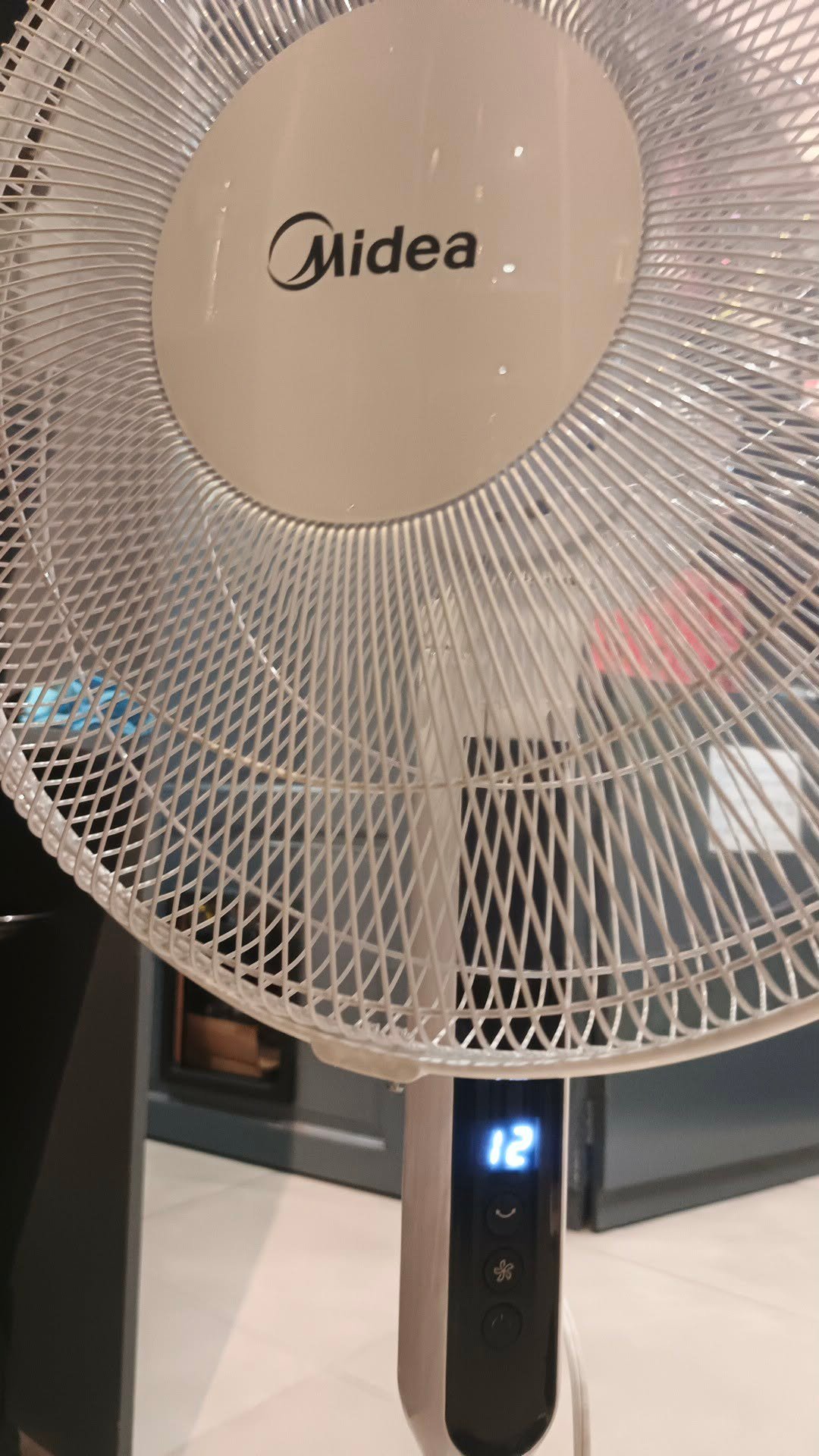 Midea inverter fan with its digital display showing speed 12