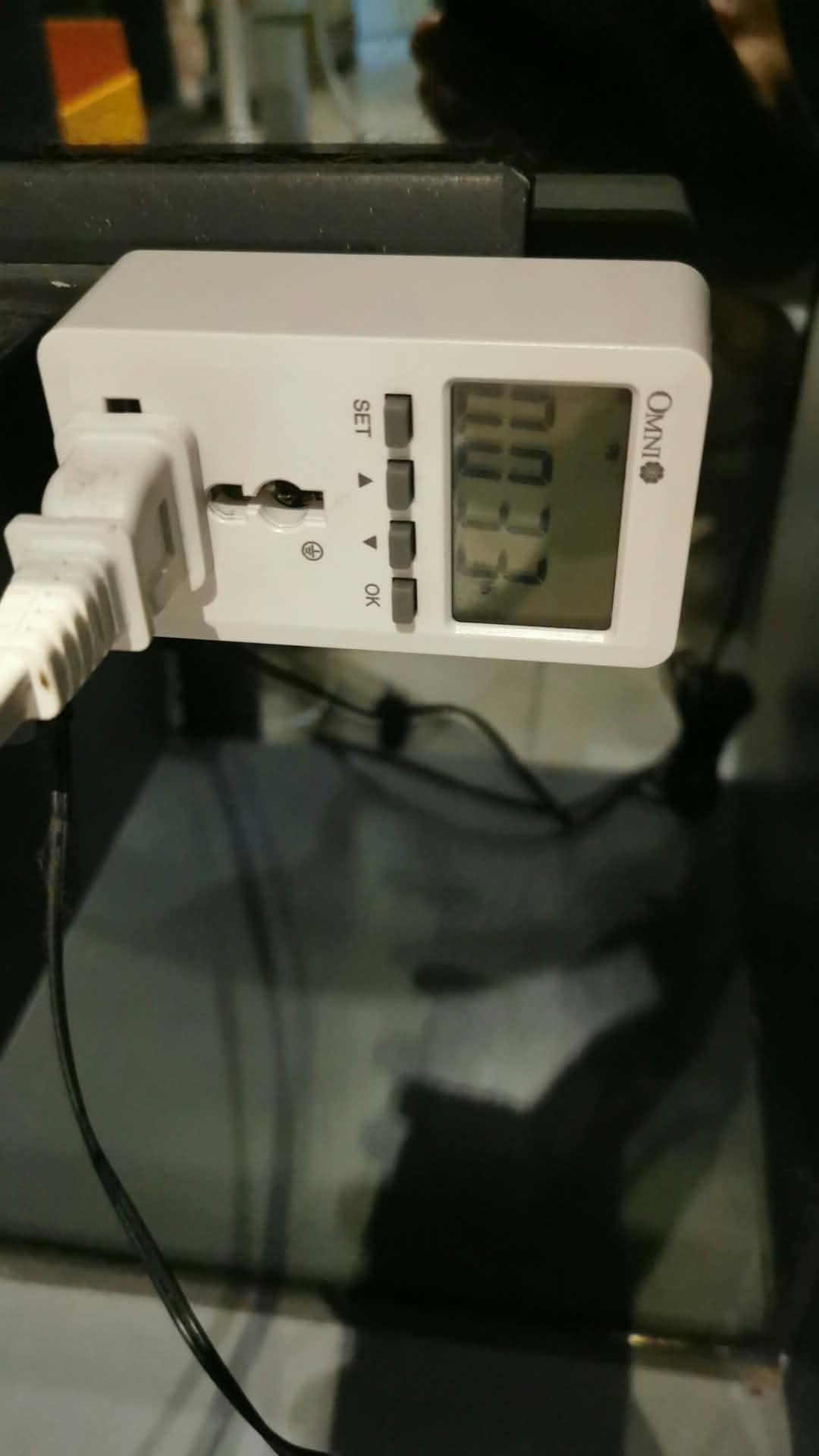 Omni wattage meter connected to a white plug during fan testing