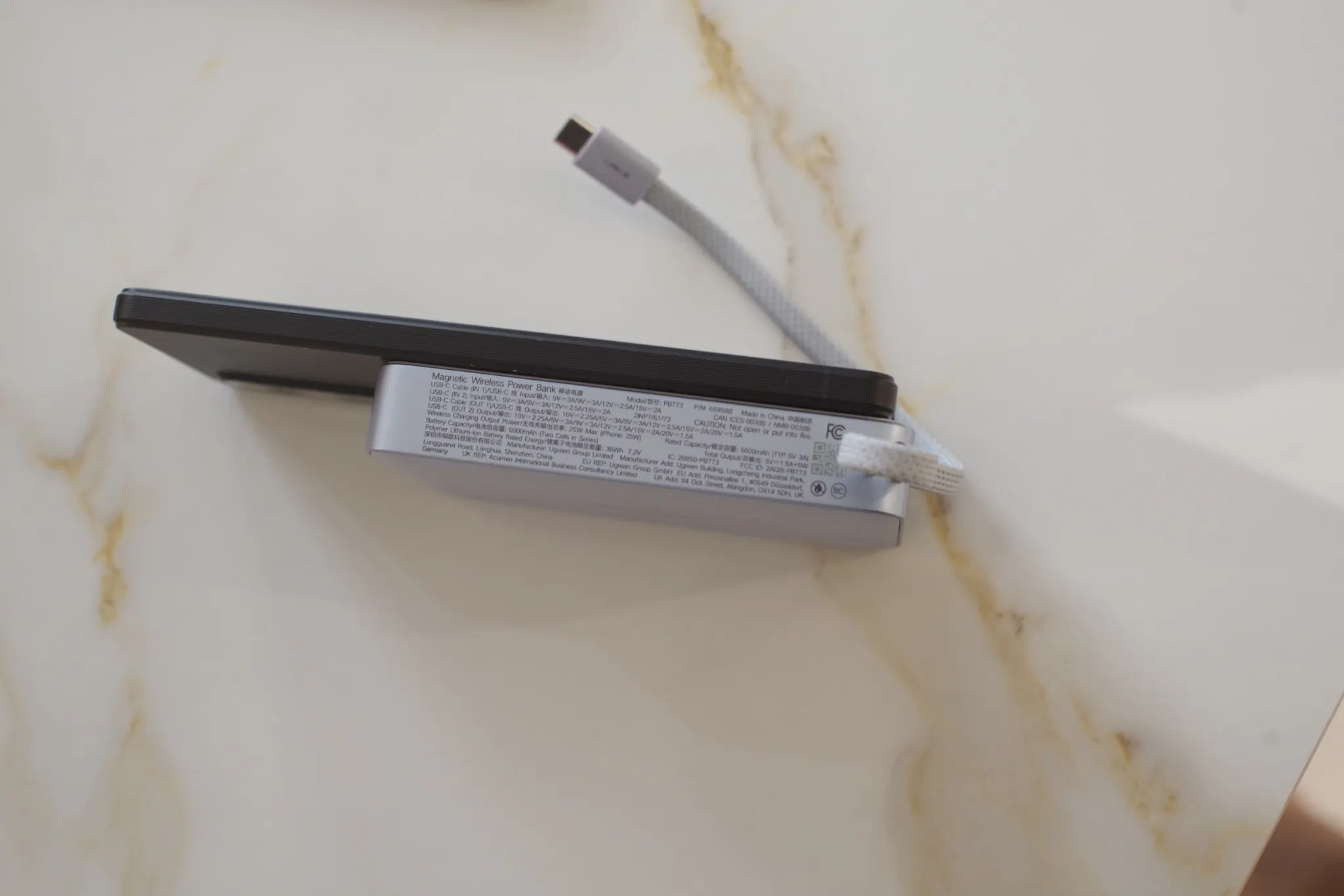 UGREEN Qi2 attached magnetically to a smartphone with 94 percent displayed on the power bank